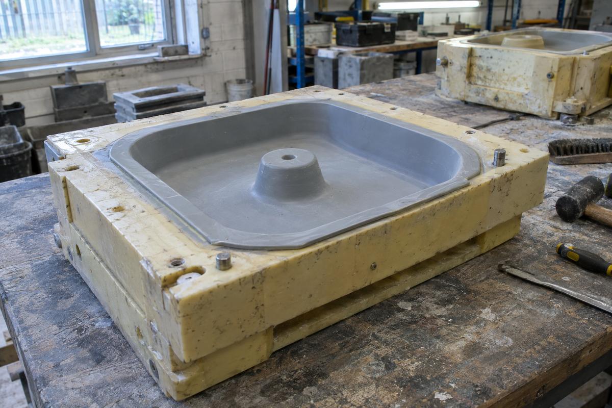 Planter base mould showing integrated drainage well and silicone insert