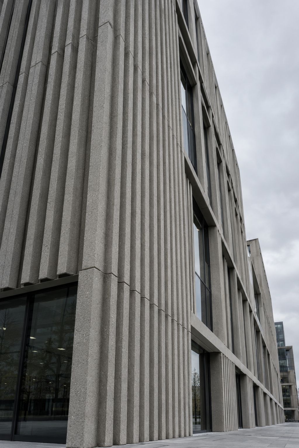 Architectural precast facade with textured panels and aligned joints.