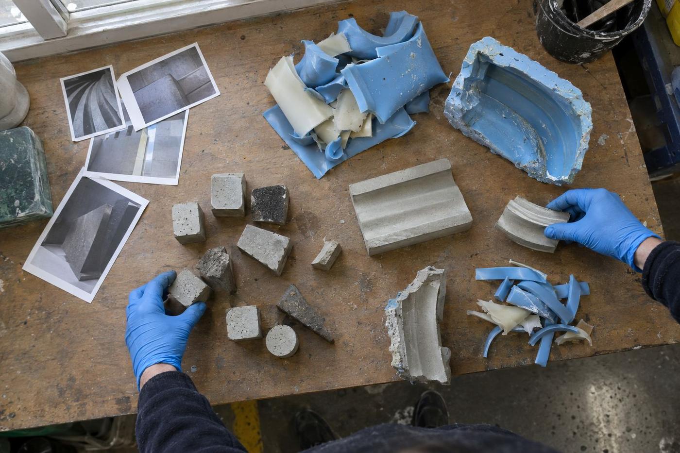 Mixed project samples and mould fragments sorted on a workshop table